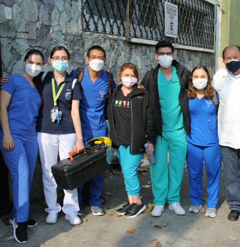 Clinical Support A group of healthcare professionals in masks, standing together outside.
